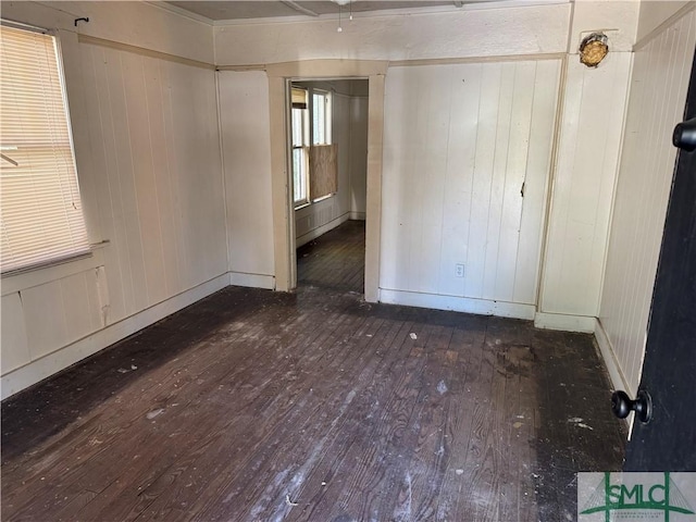 unfurnished room with baseboards and hardwood / wood-style floors