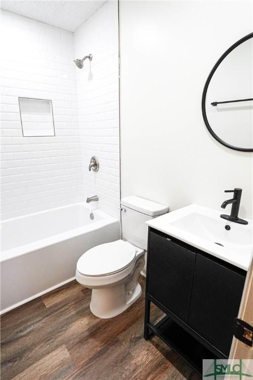 full bathroom with shower / bathtub combination, vanity, toilet, and wood finished floors