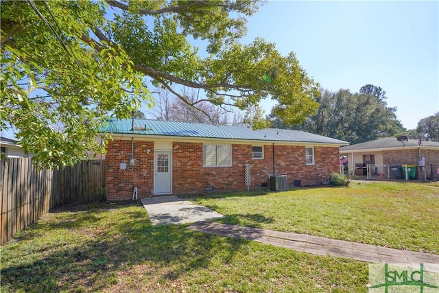 ranch-style home with brick siding, crawl space, central AC, a fenced backyard, and a front lawn