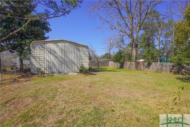 view of yard featuring a fenced backyard, an outdoor structure, and a shed