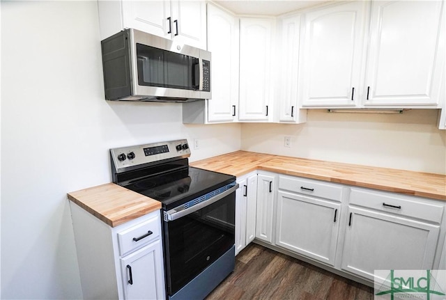 kitchen featuring appliances with stainless steel finishes, white cabinets, butcher block countertops, and dark wood-style floors