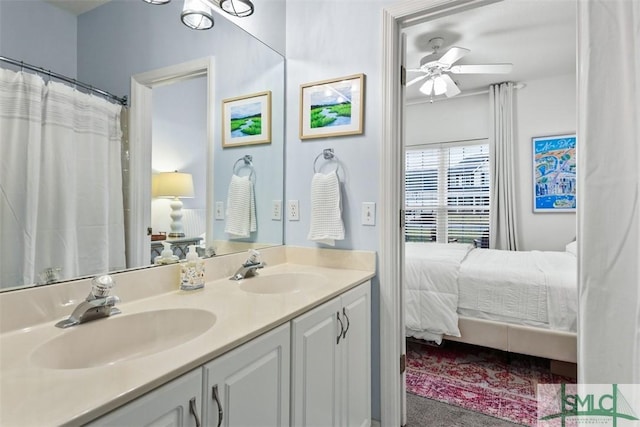 bathroom with a sink, double vanity, a ceiling fan, and connected bathroom