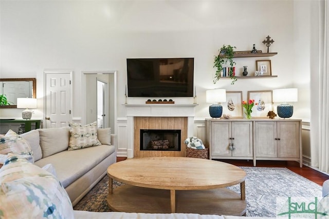 living area with a fireplace and wood finished floors