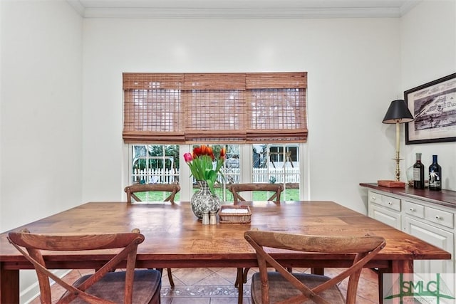 dining area with light tile patterned floors, plenty of natural light, and ornamental molding