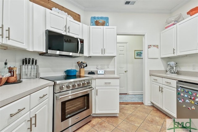 kitchen with white cabinets, ornamental molding, stainless steel appliances, and light countertops