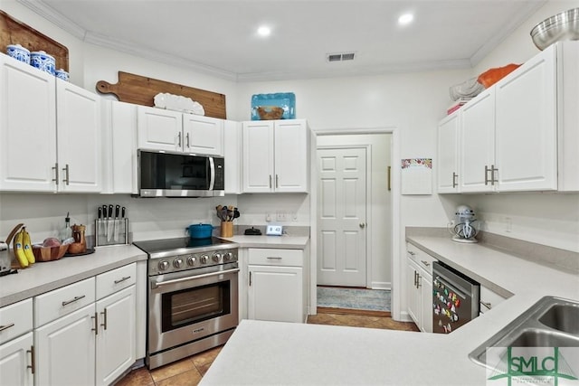 kitchen with stainless steel appliances, light countertops, and white cabinetry