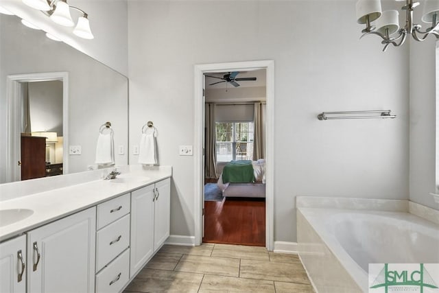 bathroom with a sink, double vanity, connected bathroom, and a bath