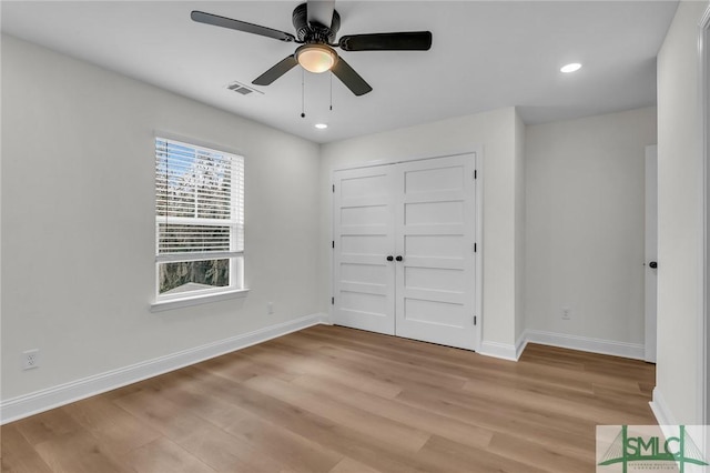 unfurnished bedroom with recessed lighting, visible vents, baseboards, light wood-style floors, and a closet