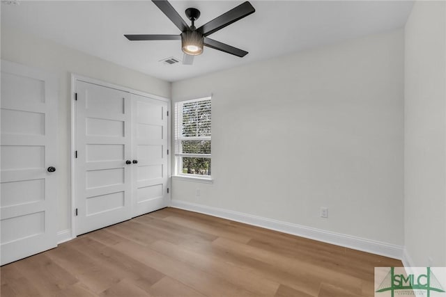 unfurnished bedroom featuring light wood-type flooring, visible vents, and baseboards