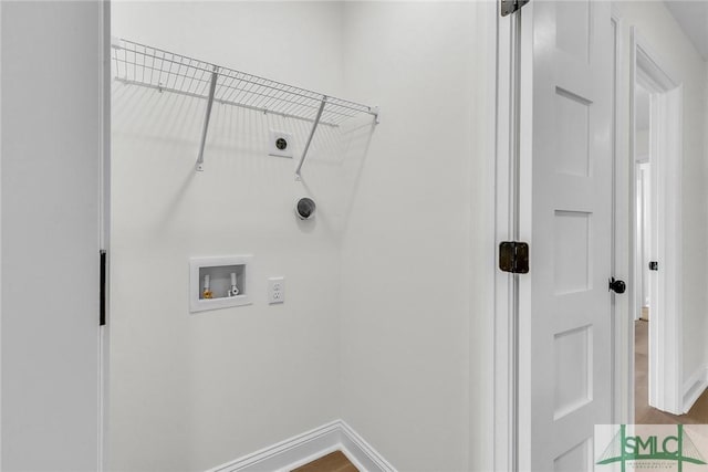 laundry room with hookup for a washing machine, electric dryer hookup, and baseboards