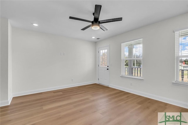 spare room with light wood-type flooring, ceiling fan, baseboards, and recessed lighting