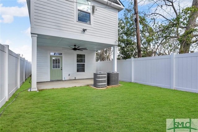 view of yard with a ceiling fan, a patio area, a fenced backyard, and central AC