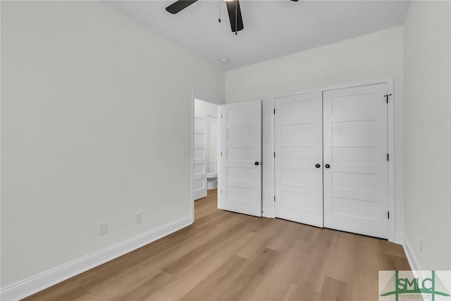 unfurnished bedroom with ceiling fan, light wood finished floors, a closet, and baseboards