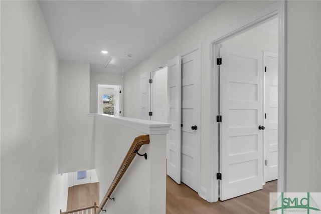 hallway featuring light wood finished floors and an upstairs landing