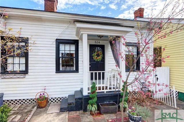 doorway to property with a chimney