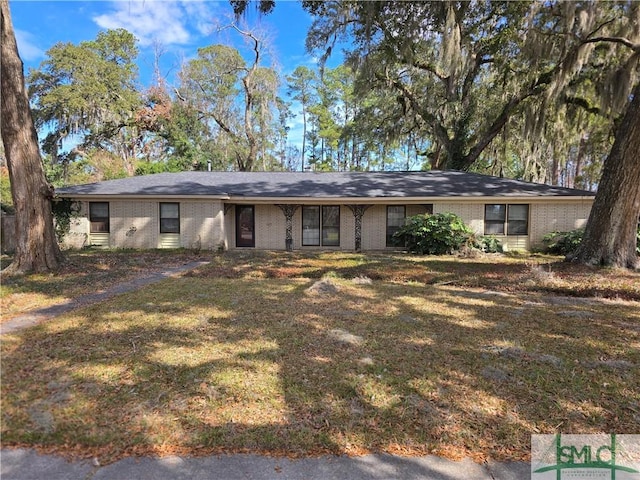 single story home featuring brick siding and a front lawn