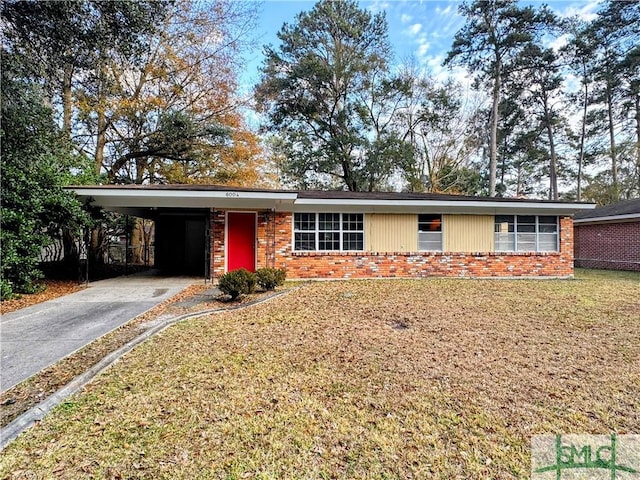 ranch-style home featuring driveway, a front yard, a carport, and brick siding