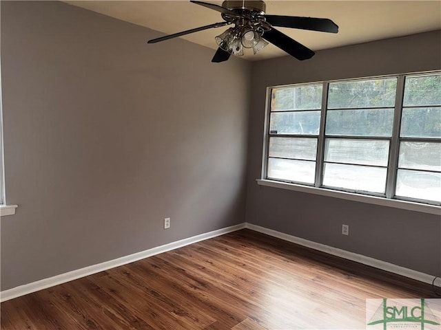 unfurnished room with light wood-type flooring, baseboards, and a wealth of natural light