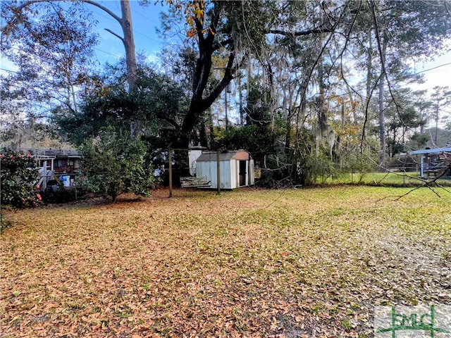 view of yard featuring an outbuilding and a shed