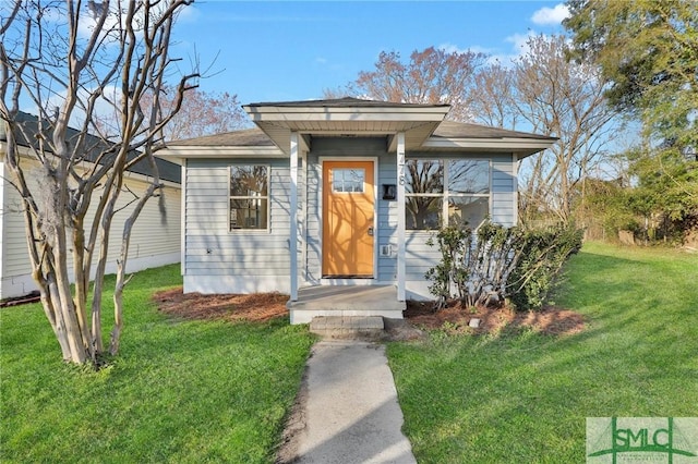 bungalow-style house featuring a front yard