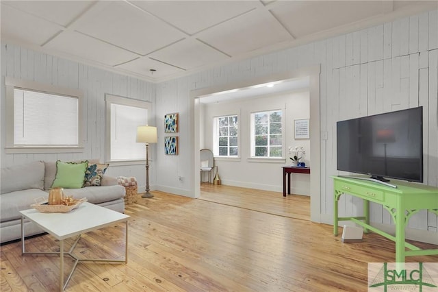 living room featuring coffered ceiling, wood finished floors, and baseboards