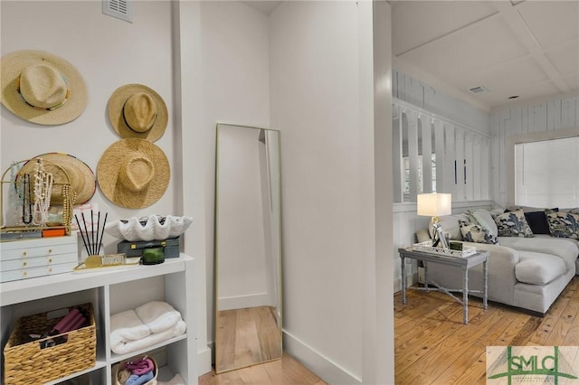 interior space with baseboards, visible vents, and wood finished floors