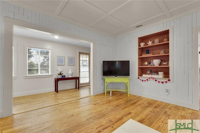 unfurnished living room featuring baseboards, visible vents, coffered ceiling, wood finished floors, and built in shelves