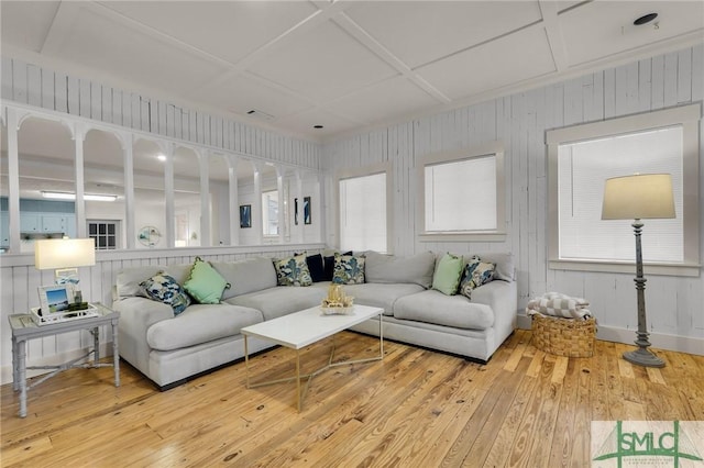 living room with coffered ceiling and wood finished floors