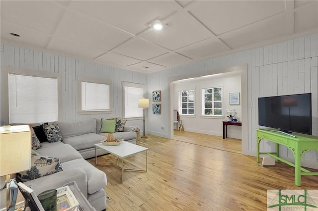 living area with light wood-type flooring, baseboards, and coffered ceiling