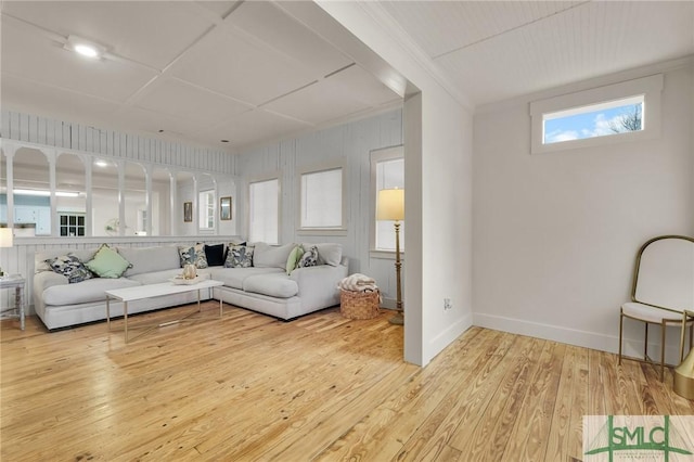 living room with crown molding, wood finished floors, and baseboards