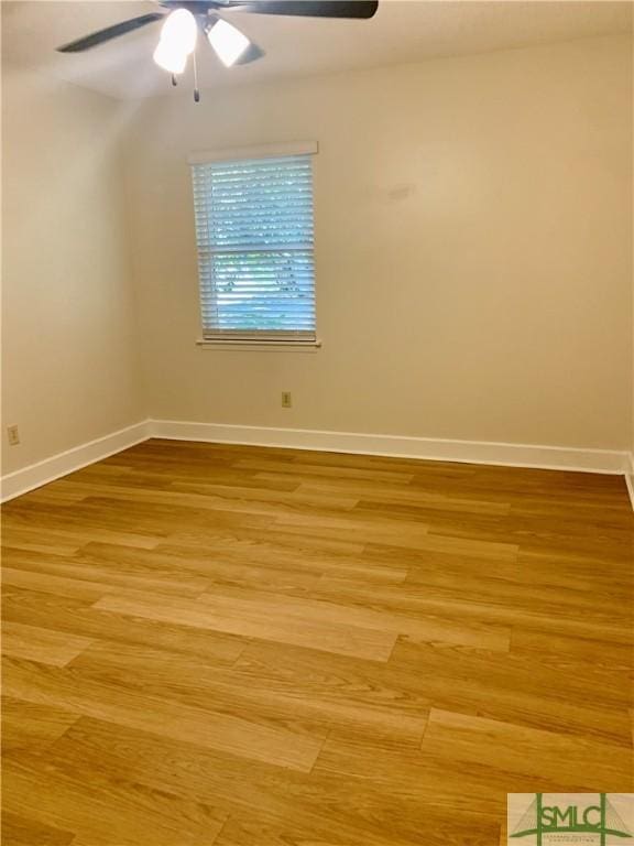unfurnished room featuring ceiling fan, wood finished floors, and baseboards