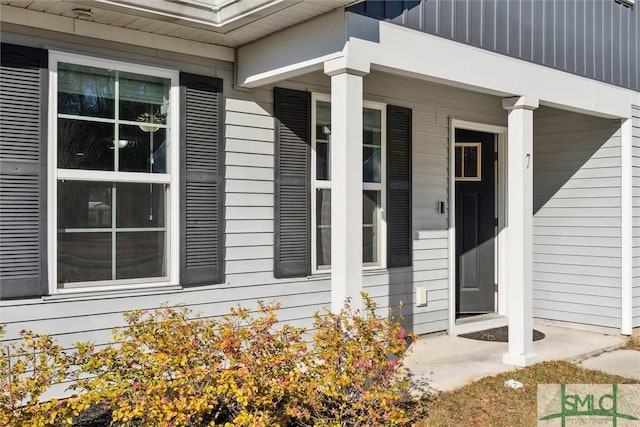 entrance to property with covered porch and board and batten siding