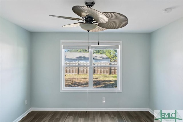 unfurnished room featuring ceiling fan, dark wood-type flooring, and baseboards