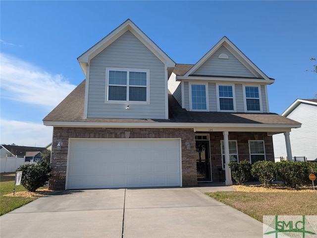 view of front of house with driveway, stone siding, a garage, and covered porch