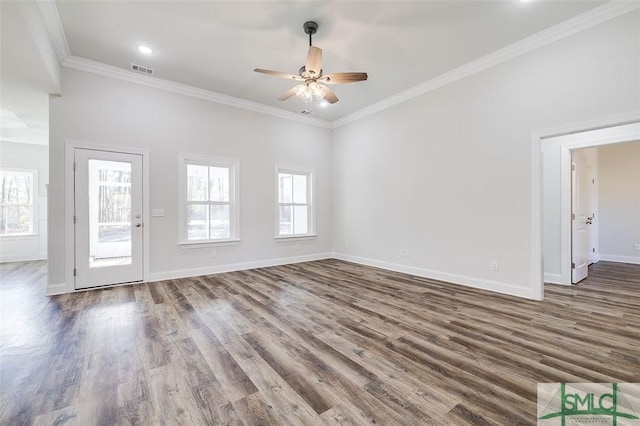 unfurnished living room with ornamental molding, a wealth of natural light, visible vents, and wood finished floors