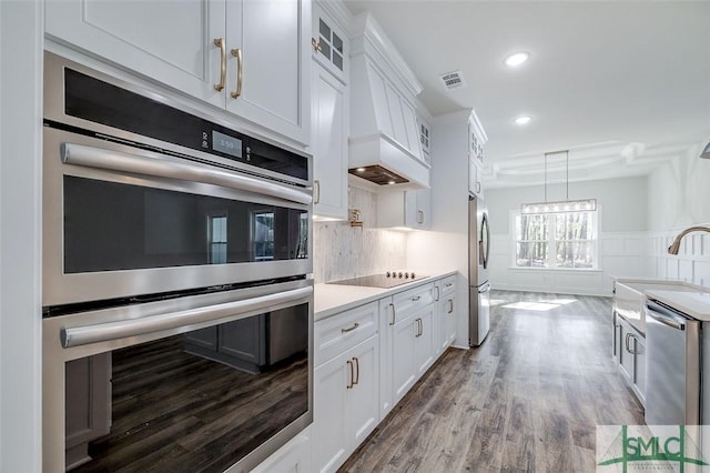 kitchen featuring visible vents, white cabinets, appliances with stainless steel finishes, glass insert cabinets, and light countertops