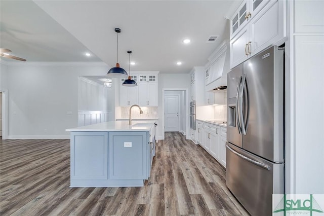 kitchen featuring light countertops, appliances with stainless steel finishes, glass insert cabinets, and white cabinetry