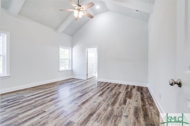 empty room with baseboards, wood finished floors, beam ceiling, and a ceiling fan