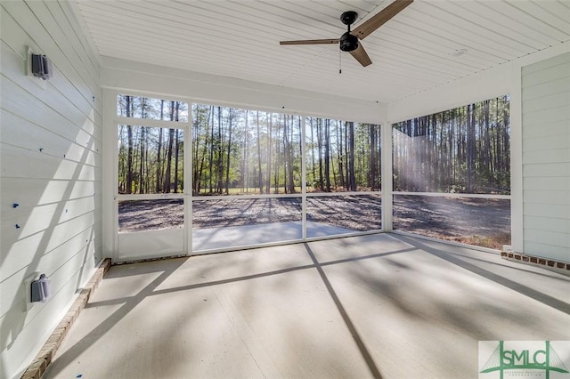 unfurnished sunroom with plenty of natural light and a ceiling fan