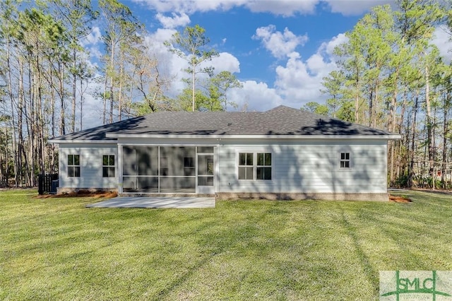 rear view of property with a sunroom, a patio area, a yard, and roof with shingles