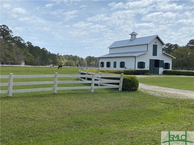 exterior space featuring an outdoor structure, fence, and a barn