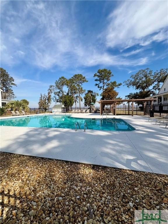 pool with fence and a patio