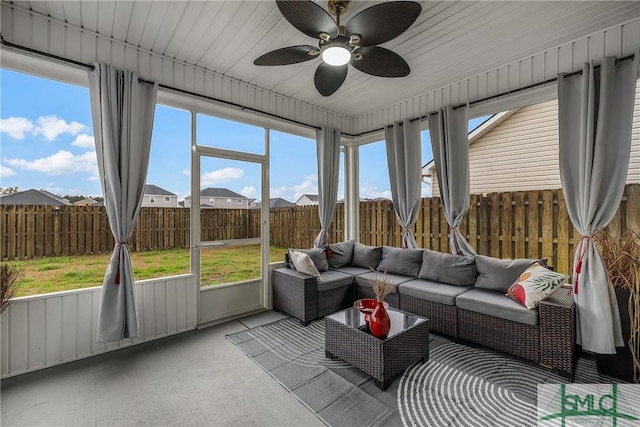 sunroom / solarium featuring ceiling fan and plenty of natural light