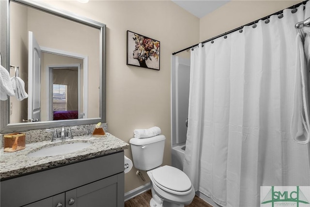 ensuite bathroom featuring ensuite bathroom, toilet, wood finished floors, vanity, and shower / bathtub combination with curtain