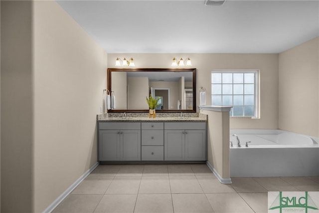 bathroom with double vanity, baseboards, tile patterned floors, a sink, and a bath