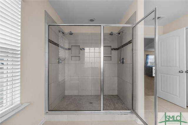 full bathroom featuring a shower stall, visible vents, and tile patterned floors