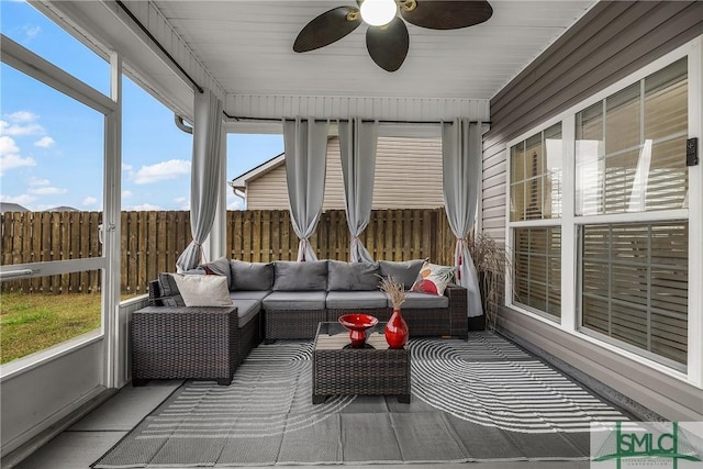 sunroom featuring plenty of natural light and a ceiling fan