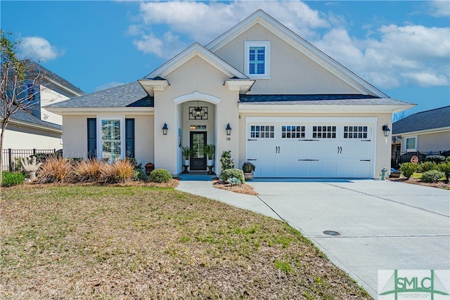 view of front of home featuring driveway, a front lawn, fence, and stucco siding