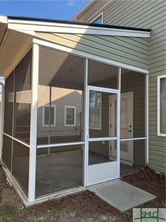 view of property exterior with a sunroom