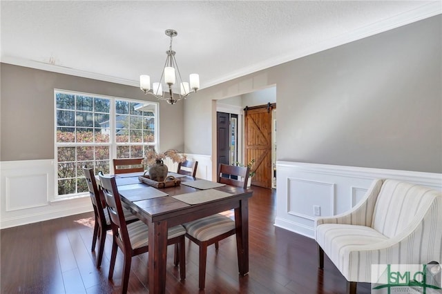 469 Nashview Trl, Allenhurst, GA 31301 - dining room with a barn door, a wainscoted wall, dark wood-style flooring, ornamental molding, and an inviting chandelier